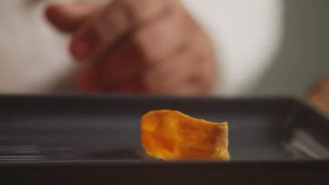 Chef placing a piece of fried sweet potato on a tray Stock Footage 274669560