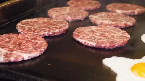 Chef Placing Raw Wagyu Beef Burger Patties on Hot Griddle flat top 스톡 동영상 347687639