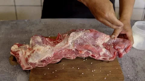 Chef placing salt on meat, beef rib. Restaurant concept, food preparation Stock Footage 272282180