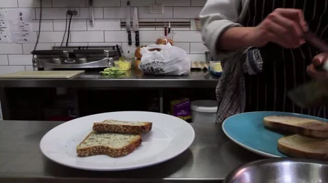 A chef plates up eggs on toast Stock Footage 53257578