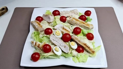 Chef Plating Caesar Salad with Chicken and Quail Eggs using Gold Tongs 4K 스톡 동영상 333371282