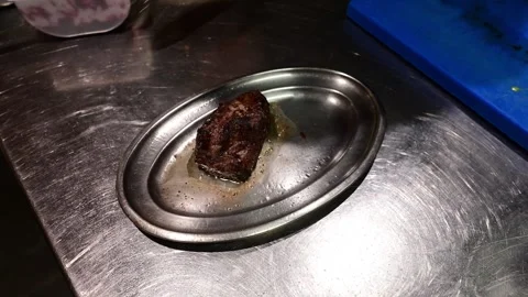 Chef plating a delicious grilled beef fillet in a gourmet restaurant kitchen Stock Footage 327581797