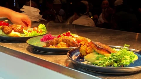 Chef Plating Gourmet Dishes on Restaurant Kitchen Pass in Norway Under Warm Stock Footage 340254872