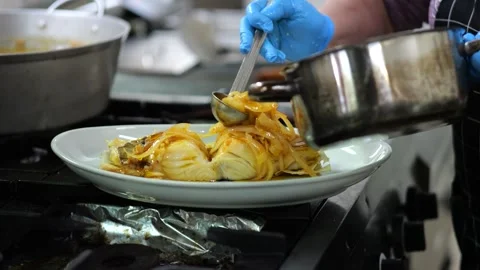 Chef Plating Potatoes and Fish in a Restaurant Kitchen Stock Footage 341678951