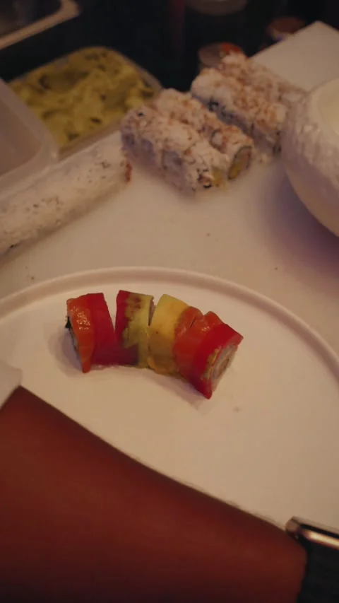Chef plating rainbow sushi roll with black gloves – 4K overhead vertical Stock Footage 315419197