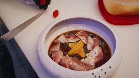 Chef plating red snapper sashimi with soy sauce citrus and cherry tomatoes 4K Stock Footage 315990445