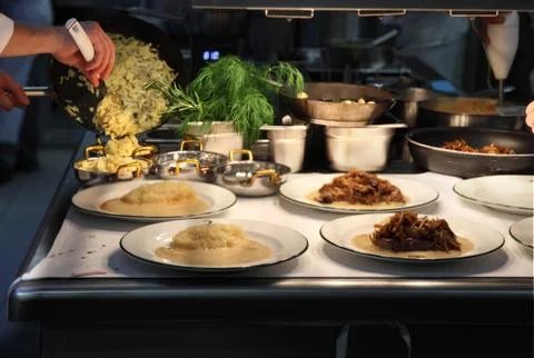 Chef plating up in a restaurant kitchen Stock Photos