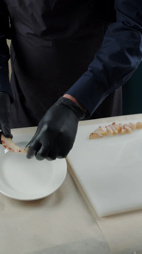 Chef plating sliced smoked fish fillet Stock Footage 308073814