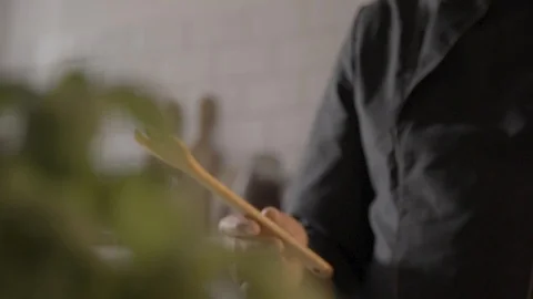 Chef is playing with a wooden spoon Vídeos de archivo 93536088