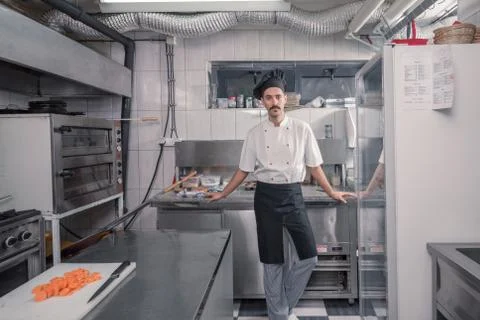 Chef posing, looking at camera, commercial kitchen Stock Photos