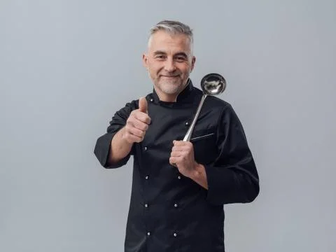 Chef posing with a spoon ladle Stock Photos