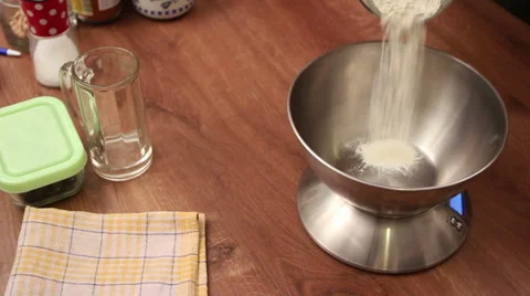 Chef pour wheat flour onto kitchen scale Stock Footage 44726137