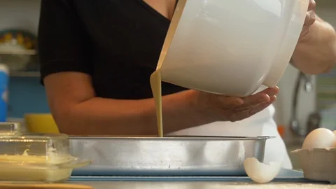 Chef pouring batter into the baking pan Stock-Footage 128002628