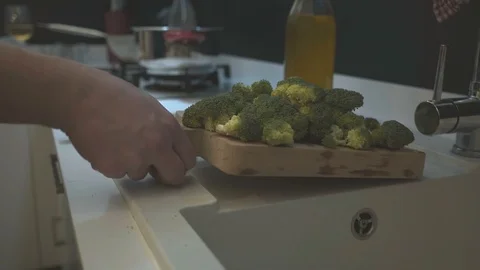 Chef Pouring Broccoli in a Pot Stock Footage 125982471
