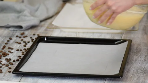 Chef pouring cake batter in a baking tin, close up. Stock Footage 123652556