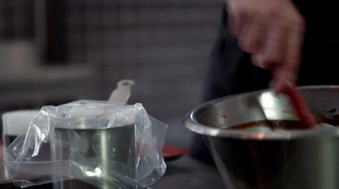 Chef pouring chocolate into cases. Stock Footage 64117478