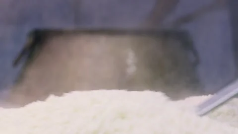 Chef pouring cooked rice for pilaf from large cauldron with long ladle, close-up Stock Footage 346745776