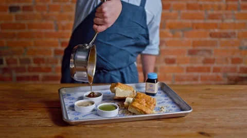 Chef Pouring Gravy on Biscuits Stock Footage 244360986