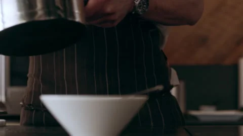 Chef pouring ingredients from a steaming pot into a tray in interior kitchen wit Video stock 199455876