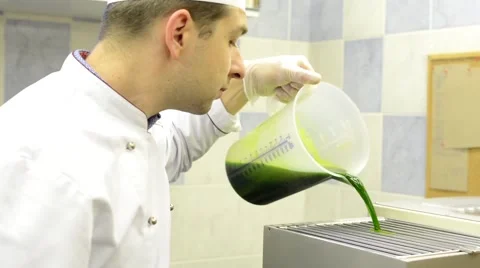 Chef pouring the mixture (spinach plant) into the device Video stock 48726808