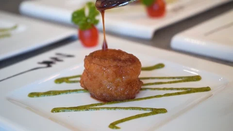 Chef pouring sauce onto fried chinese scallops , slow mo Stock Footage 105211448
