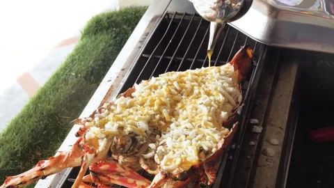Chef Pouring Sauce Over Grilled Lobster Thermidor with Melted Cheese on Grill Stock Footage 344231935