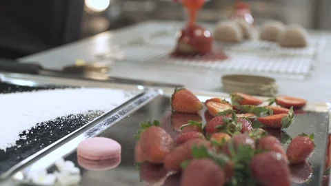 Chef pouring strawberry jam on cake at the bakery, slow motion Stock Footage 121963318