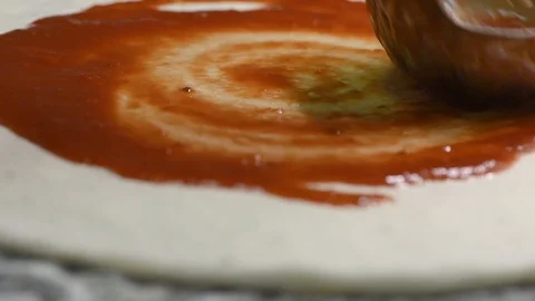Chef pouring tomato sauce over pizza in restaurant Stock Footage 100819078