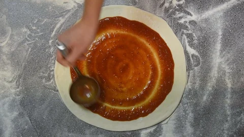 Chef pouring tomato sauce over pizza in restaurant Stock Footage 100819147