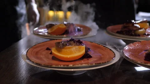 Chef pours absinthe on the roasted duck and sets the dish on fire Stock Footage 148323166