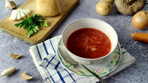 The chef pours borscht into an empty white plate Stock Footage 225480213