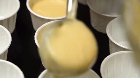 The chef pours the dough into molds, filled muffins Stock Footage 156693287