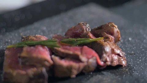 The chef pours a filleted mignon with melted butter Stock-Footage 106924101