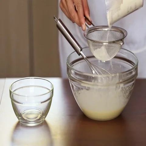 Chef pours the flour through a sieve Stock Footage 69704692