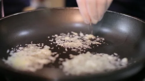 Chef pours grated cheese on the pan Stock Footage 67863278