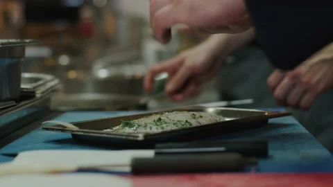 Chef pours lemon juice on fish Stock Footage 223912932