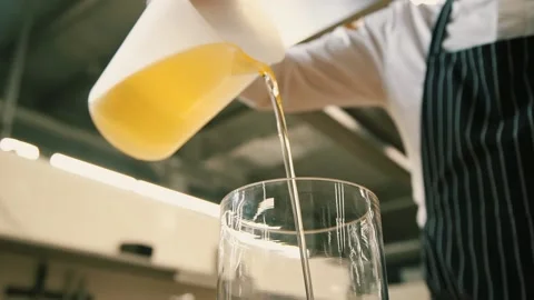 The chef pours oil into a container Stock-Footage 148499508