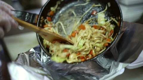 The chef pours from the pan of freshly cooked dish Stock Footage 59699392