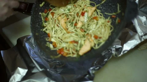 The chef pours from the pan of freshly cooked dish Stock Footage 59699979