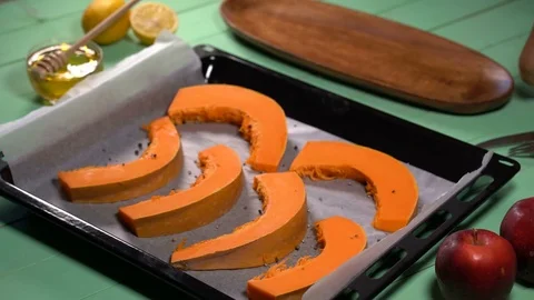 Chef pours pumpkin slices with olive oil Stock Footage 81393336