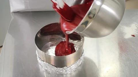Chef pours red dough into baking dish with foil bottom Stock Footage 139487169
