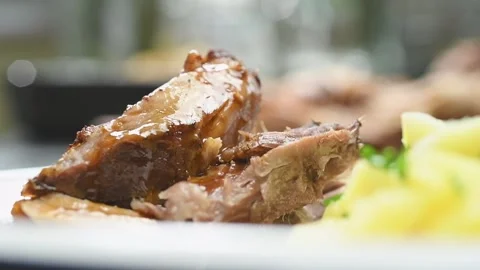 Chef pours sauce over roasted pork shoulder. Stock Footage 170904371