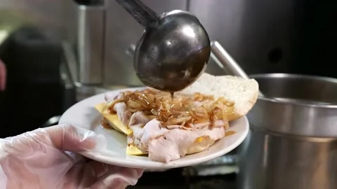 The chef pours the sauce on the sandwich Stock Footage 171360802