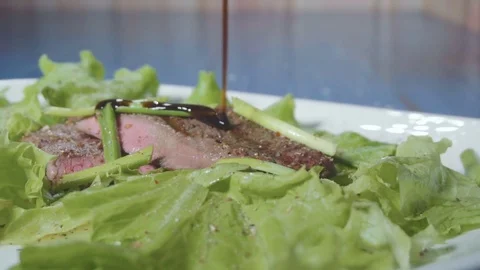 Chef pours sauce steak Stock Footage 73816420