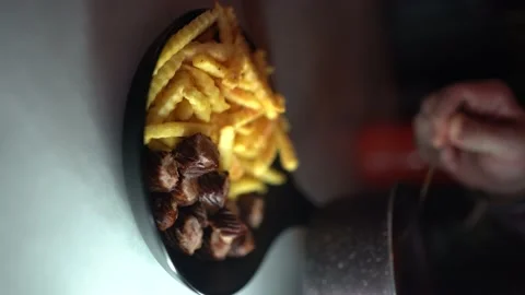 Chef pours tomato paste sauce over french fries and sausage Video stock 181013251