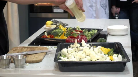 The chef pours the vegetables with sauce. Broccoli, cauliflower in a tray Stock Footage 87614039