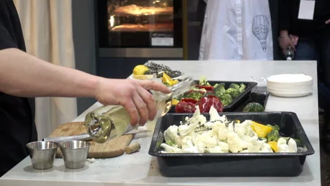 The chef pours the vegetables with sauce. Stock Footage 87614061