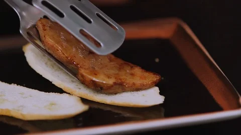 Chef preparation of the dish puts on the bread meat in restaurant kitchen Stock Footage 100306942