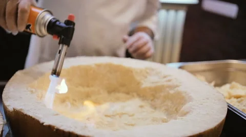 Chef prepare big cheese by fire burner Stock Footage 69029670