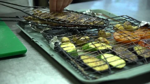 The chef prepared the fish and grilled vegetables Stock Footage 73954585